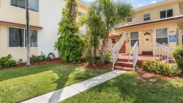 a view of a house with a yard and plants