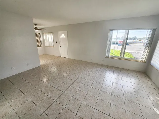 a view of an empty room with a window