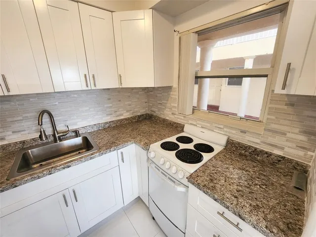 a kitchen with a sink and a window