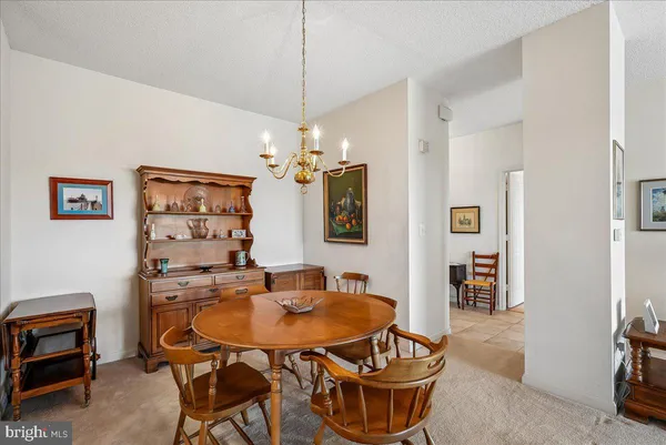 a view of a dining room with furniture and chandelier