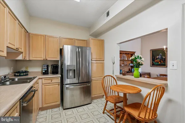 a kitchen with white cabinets stainless steel appliances and sink