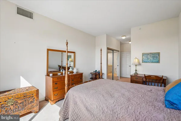 a bedroom with bed and a chandelier