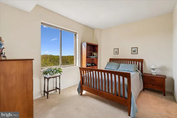 a bedroom with furniture and a window