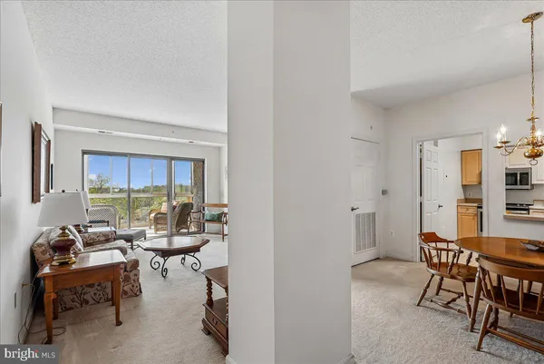 a living room with furniture a flat screen tv and a window