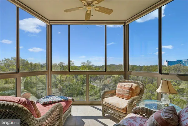 a balcony view with a couch and wooden floor