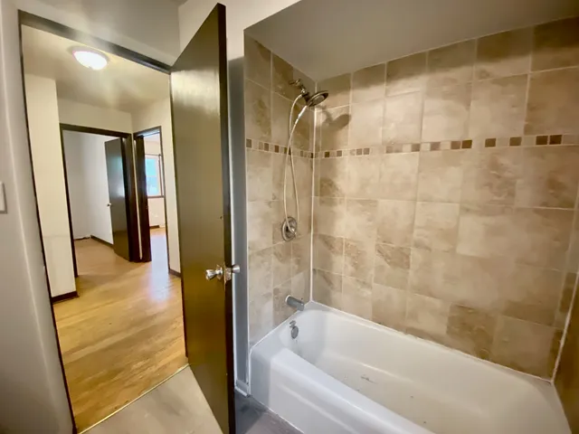 a bathroom with a bathtub and a shower