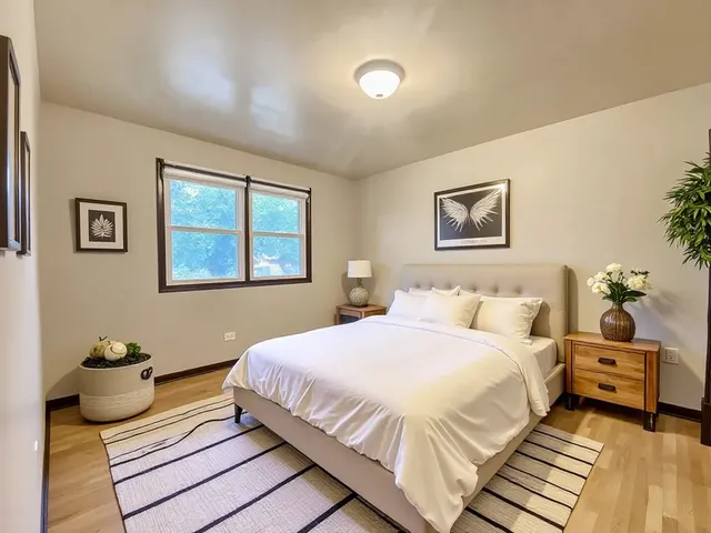 an empty room with a wooden floor and windows