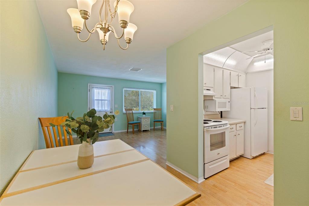 8221 112th Street North, Unit 203 Seminole, FL 33772 - Photo 11 of 31 a living room with furniture and chandelier
