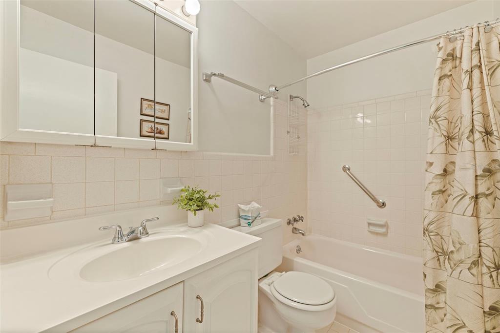 8221 112th Street North, Unit 203 Seminole, FL 33772 - Photo 19 of 31 a bathroom with a sink a toilet and a bathtub