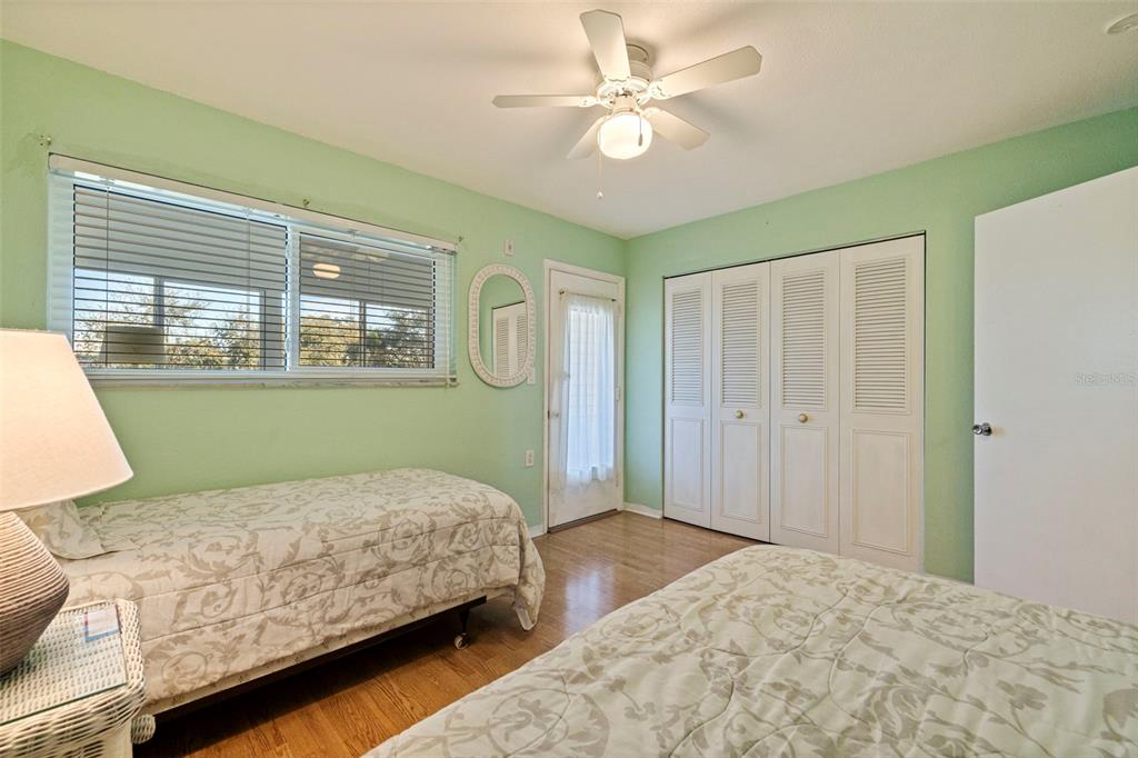 8221 112th Street North, Unit 203 Seminole, FL 33772 - Photo 23 of 31 a bedroom with a large bed and a chandelier