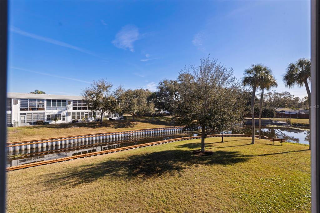 8221 112th Street North, Unit 203 Seminole, FL 33772 - Photo 27 of 31 a view of a swimming pool with an outdoor space and seating area
