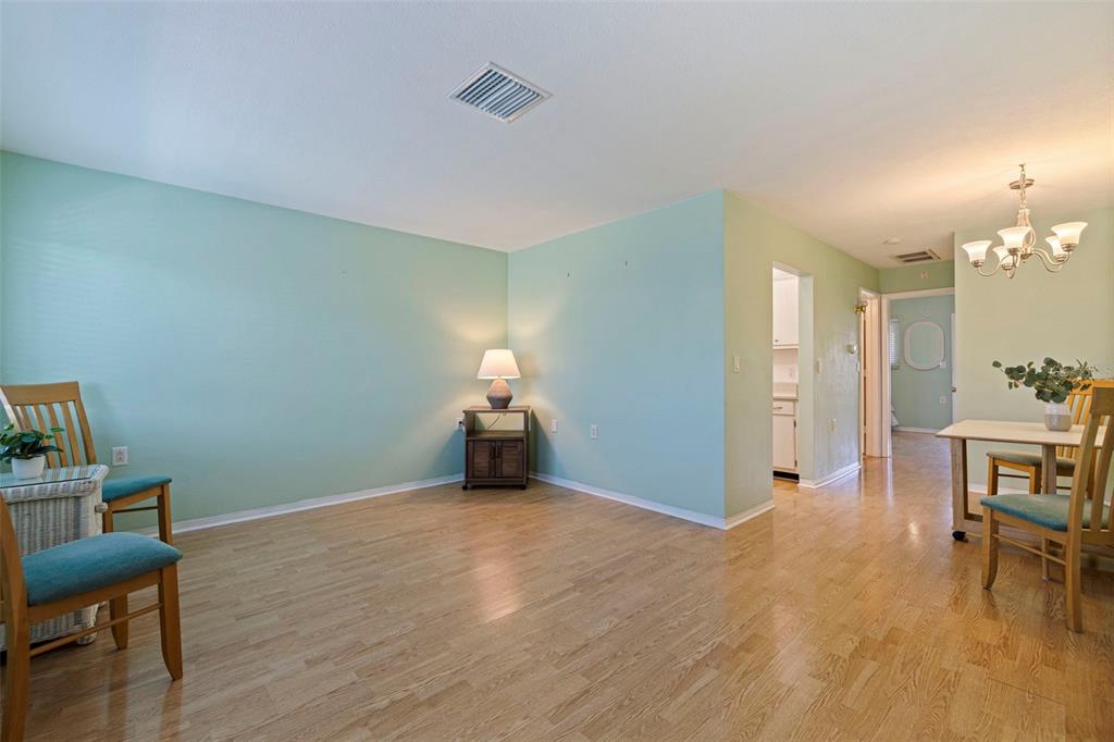 8221 112th Street North, Unit 203 Seminole, FL 33772 - Photo 6 of 31 a view of a room with furniture and wooden floor