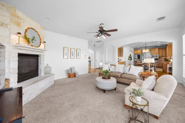 a living room with furniture potted plant and a fireplace