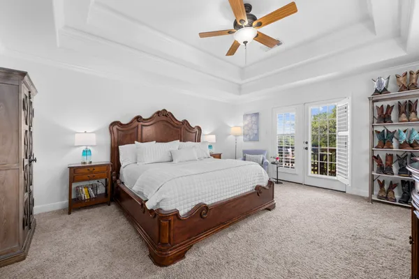 a spacious bedroom with a bed and a book shelf