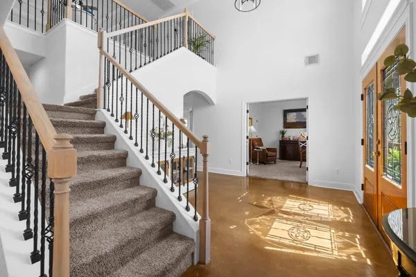 a view of entryway and hall with wooden floor