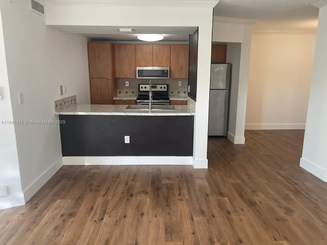 a view of kitchen with wooden floor