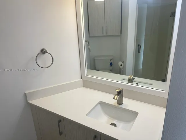 a bathroom with a sink and mirror
