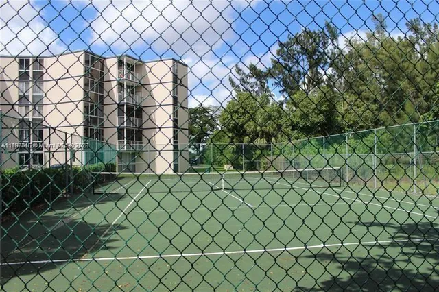 a view of a room with gym equipment and floor to ceiling window