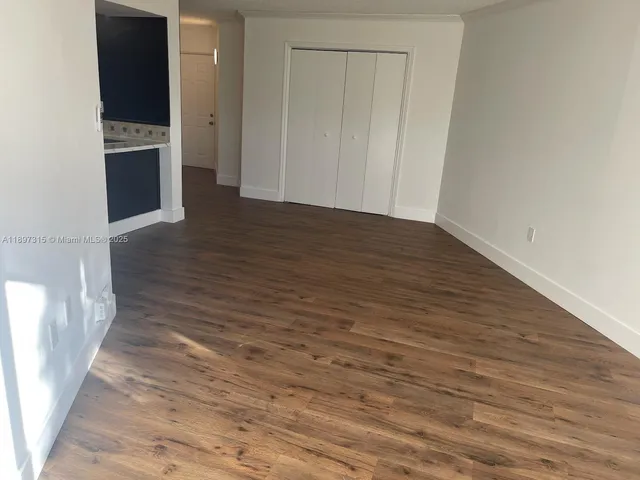 a view of a kitchen with wooden floor
