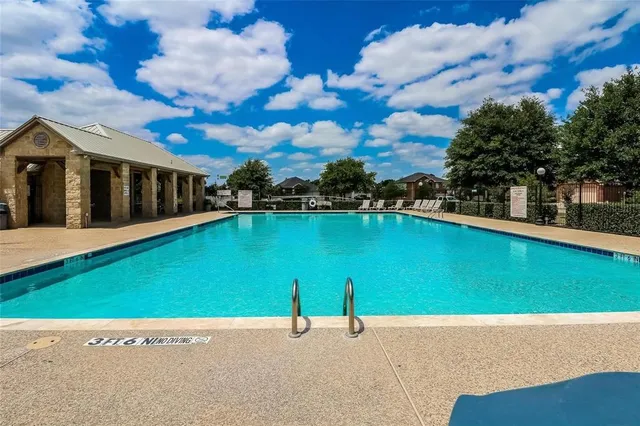 a view of swimming pool with a yard