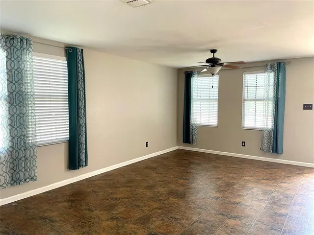 an empty room with windows and closet