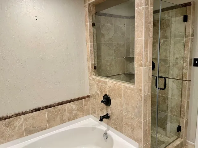 a bathroom with a bathtub and shower
