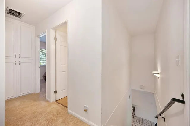 a view of a livingroom with table and cabinet