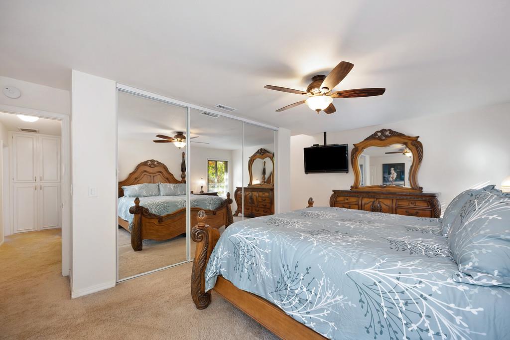 6902 Monticello Court Citrus Heights, CA 95621 - Photo 25 of 56 a bedroom with a bed and a chandelier