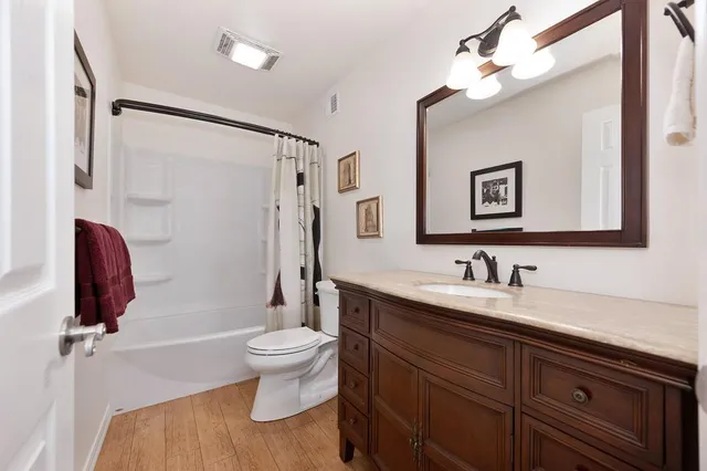 a bedroom with a bed and ceiling fan