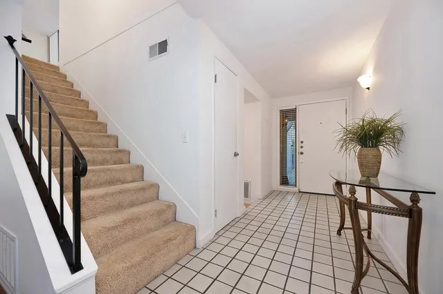 a living room with furniture a flat screen tv and a floor to ceiling window