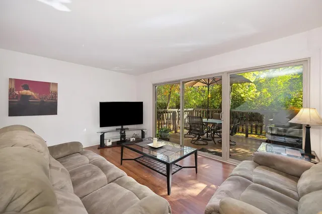 a view of a dining room with furniture wooden floor and chandelier