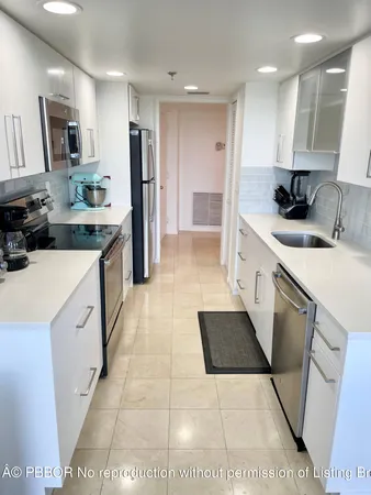 a kitchen with stainless steel appliances kitchen island granite countertop a sink and cabinets