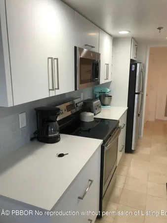 a kitchen with a sink a stove and a refrigerator
