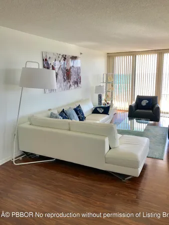 a living room with furniture window and a wooden floor