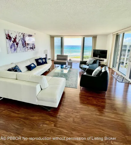 a living room with furniture window and wooden floor