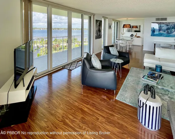 a living room with furniture and a floor to ceiling window
