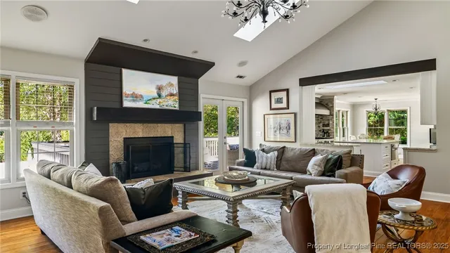 a living room with furniture and a chandelier