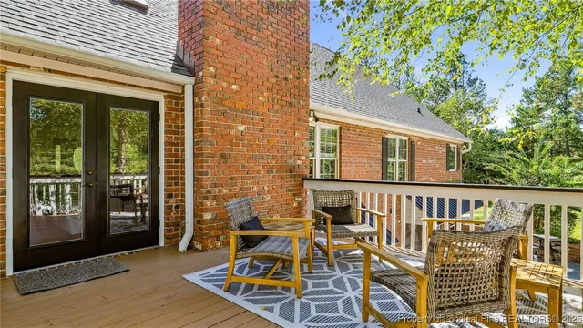 a room with furniture pool table flat screen tv and windows