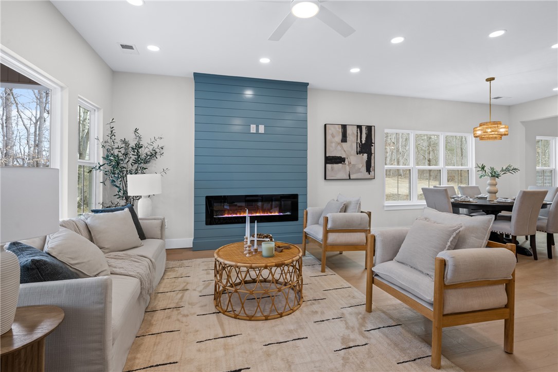 322 Oconee Avenue Westminster, SC 29693 - Photo 11 of 42 This bright living space features hardwood flooring and a stylish fireplace, seamlessly flowing into the dining area.