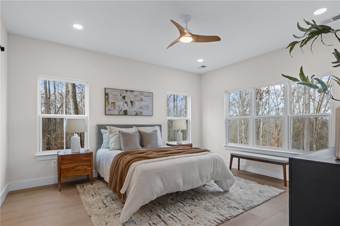 322 Oconee Avenue Westminster, SC 29693 - Photo 13 of 42 This serene bedroom offers abundant natural light and tranquil views of surrounding trees.