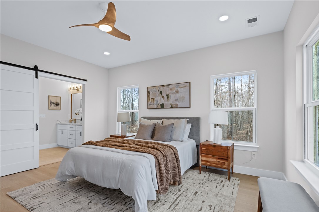 322 Oconee Avenue Westminster, SC 29693 - Photo 14 of 42 This primary bedroom offers ample natural light and direct access to a private bath.