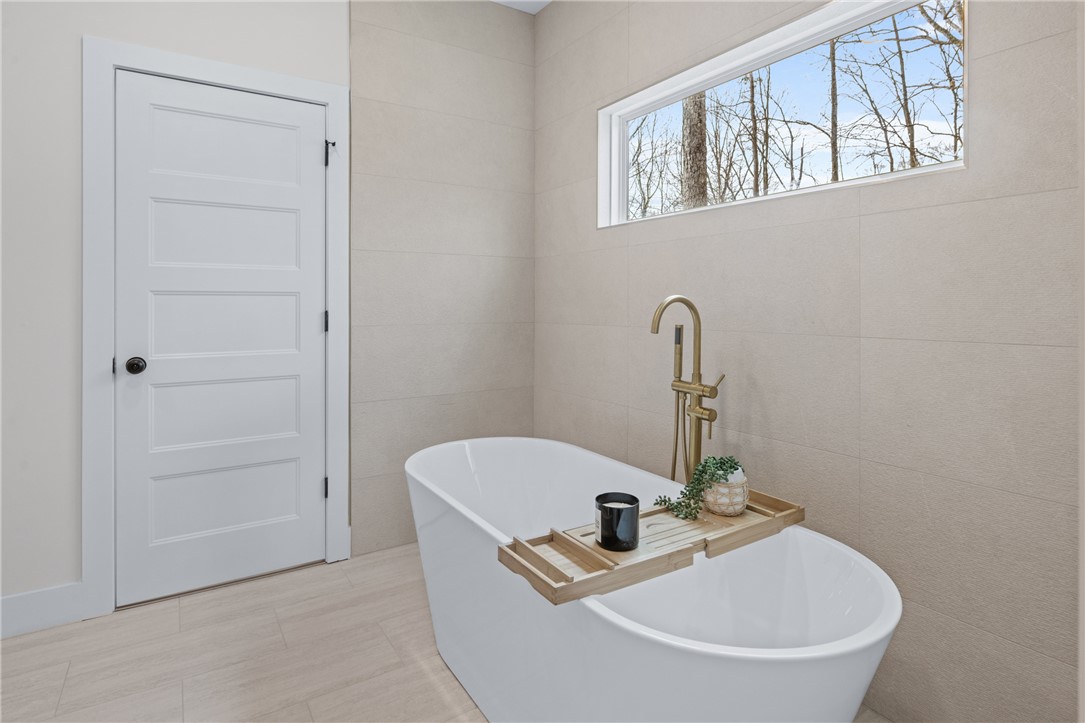 322 Oconee Avenue Westminster, SC 29693 - Photo 16 of 42 This serene bathroom offers a spacious soaking tub, perfect for unwinding after a long day.