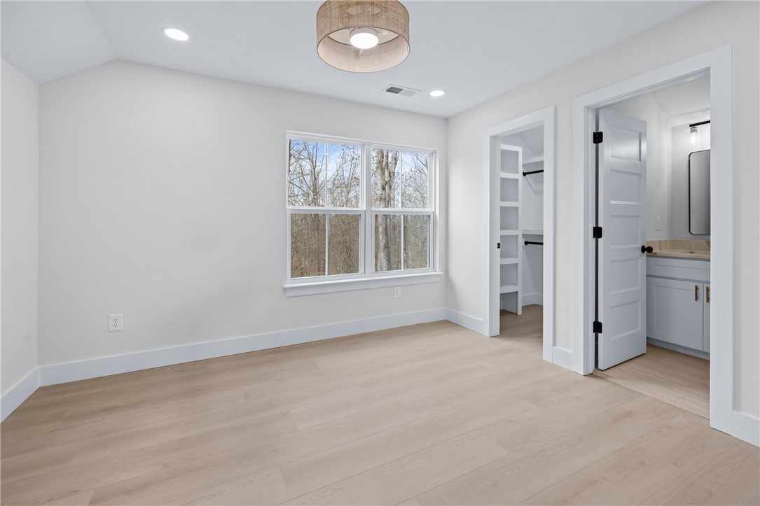 322 Oconee Avenue Westminster, SC 29693 - Photo 28 of 42 Bright and airy room with large windows, an attached bathroom, and a convenient walk-in closet.