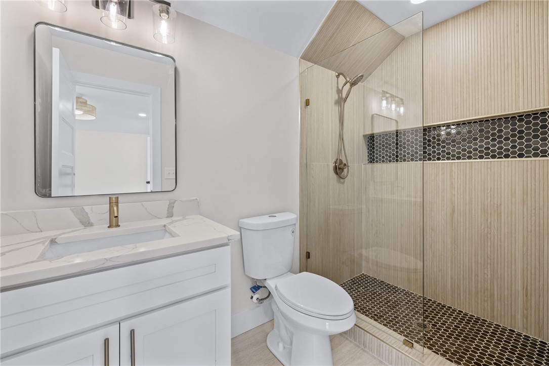 322 Oconee Avenue Westminster, SC 29693 - Photo 30 of 42 This sleek bathroom features a contemporary vanity, elegant shower, and modern fixtures.