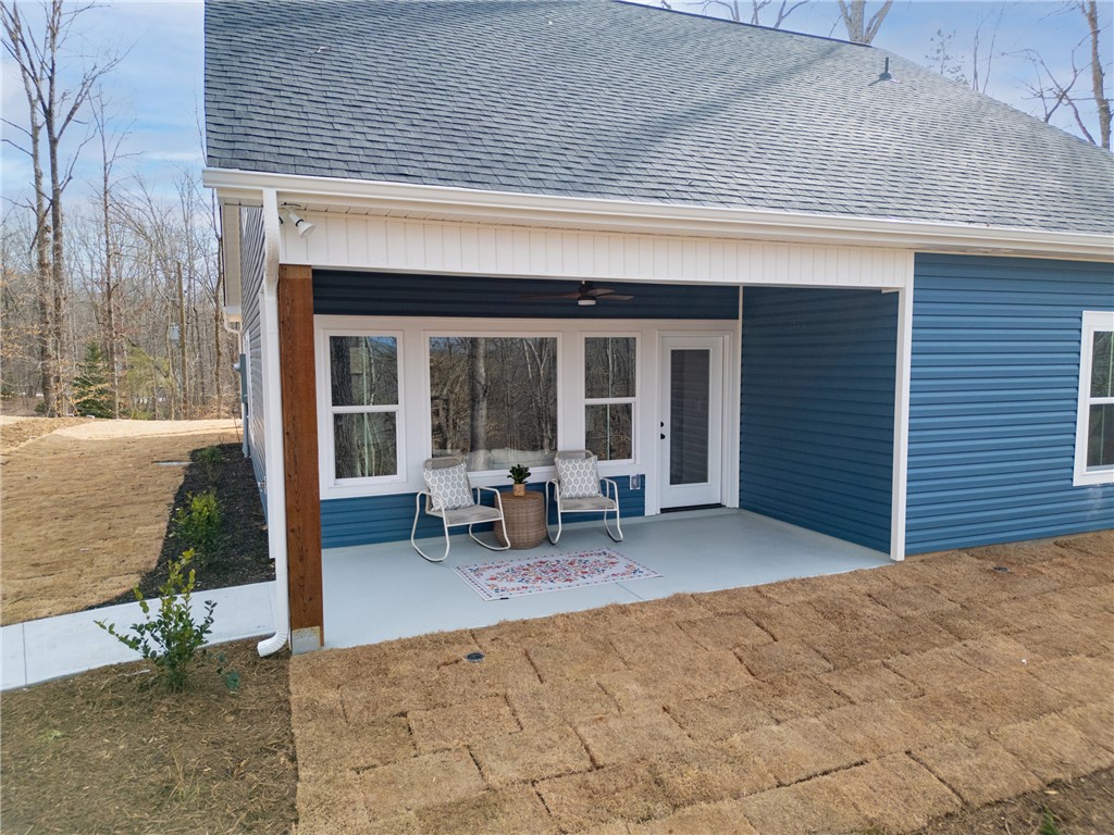 322 Oconee Avenue Westminster, SC 29693 - Photo 32 of 42 Relax on this inviting covered patio, offering a serene outdoor retreat.