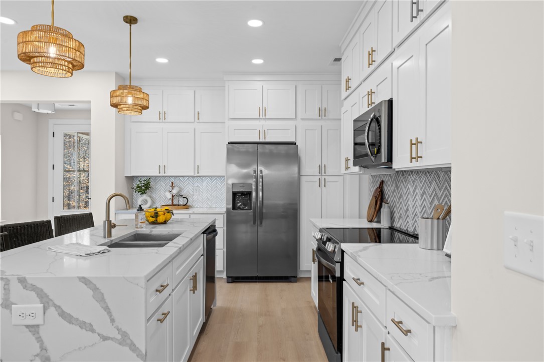 322 Oconee Avenue Westminster, SC 29693 - Photo 8 of 42 This bright kitchen features sleek appliances and ample counter space for culinary endeavors.