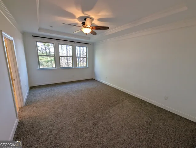 a view of a hallway with wooden floor and stairs