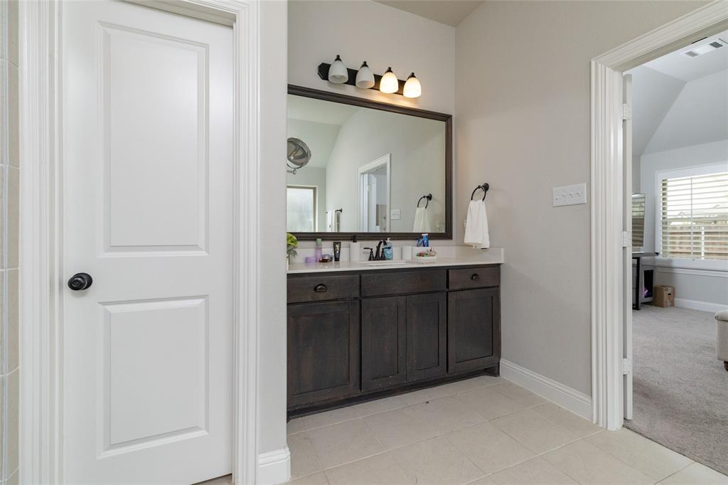 4045 Grove Valley Road Midlothian, TX 76065 - Photo 24 of 34 Bathroom with vanity, light tile patterned floors, light carpet, and lofted ceiling