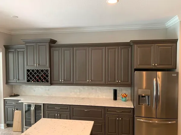 a kitchen with a refrigerator and cabinets