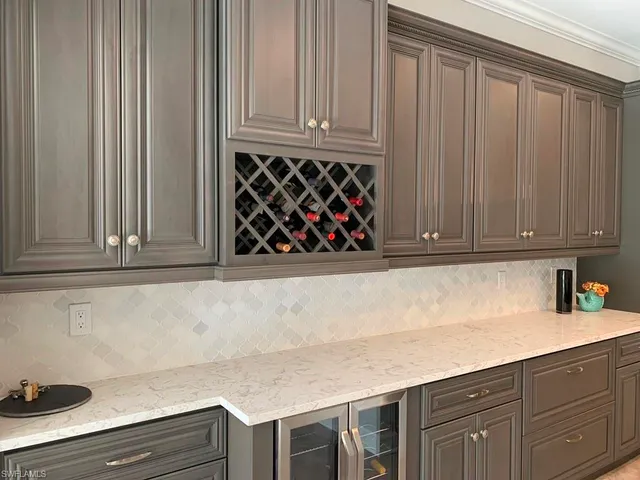a kitchen with granite countertop white cabinets and sink